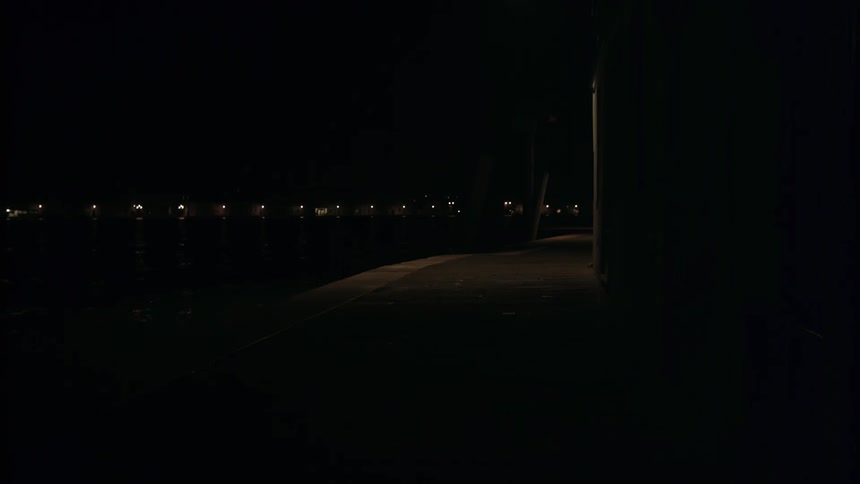 The area is very dark with a small path