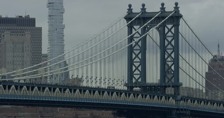 Vehicles driving over a large bridge in a city
