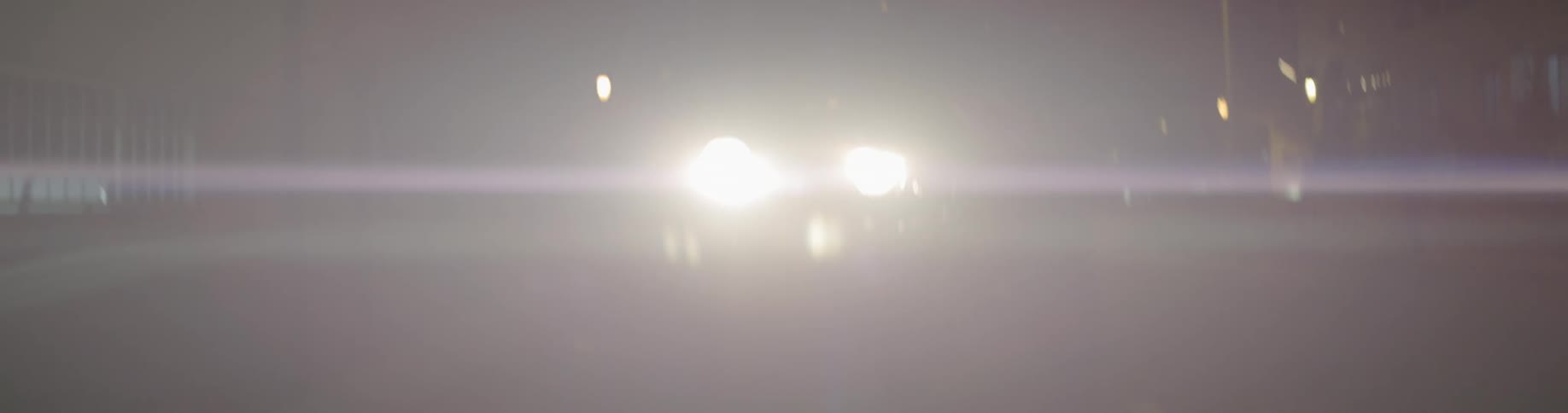 Car headlights on a road at night