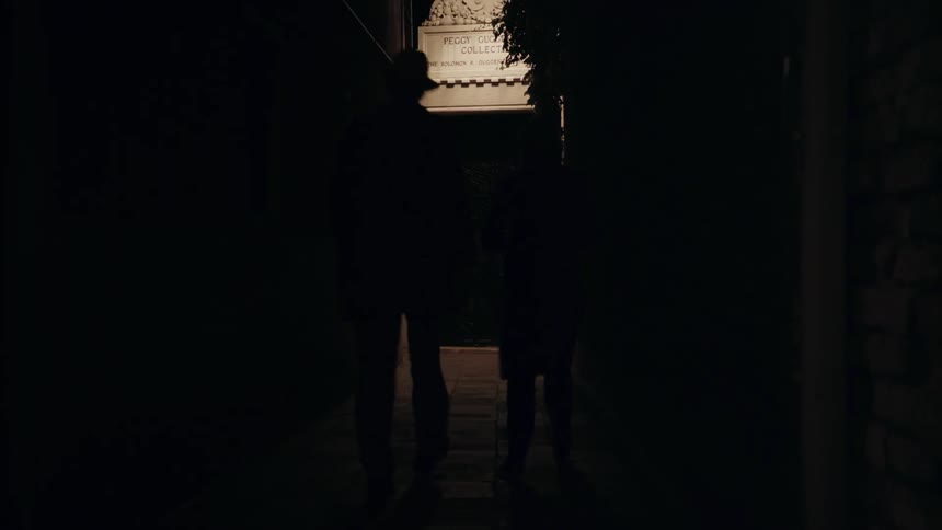 People walking up to a building at night