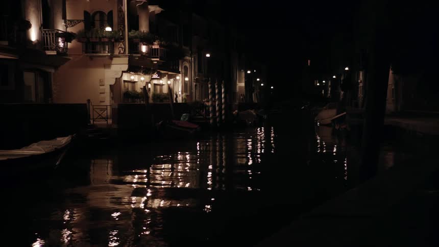 The water is calm by the buildings around this canal