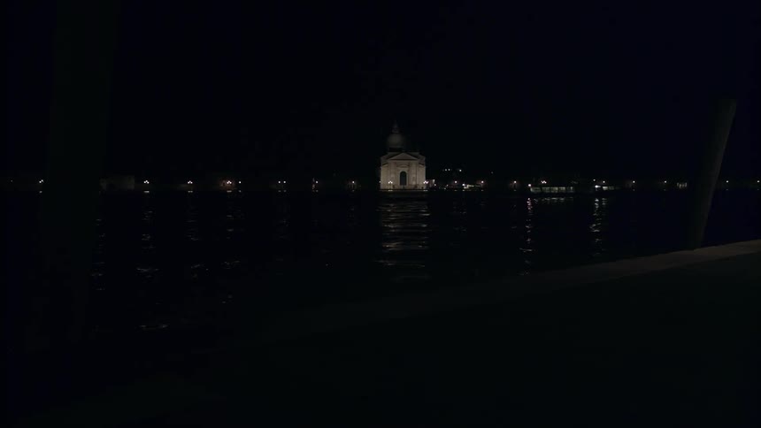 Boat floating down a river at night