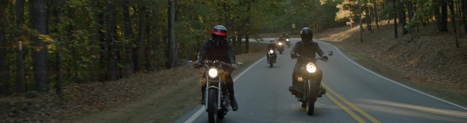Motorcyclists ride on a rural road