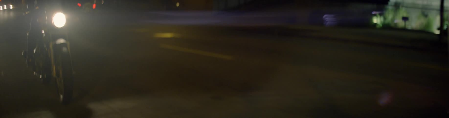 A car drives on a road at night