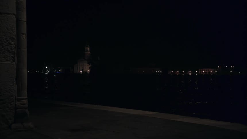 Lights are shown in the distance on a dark night