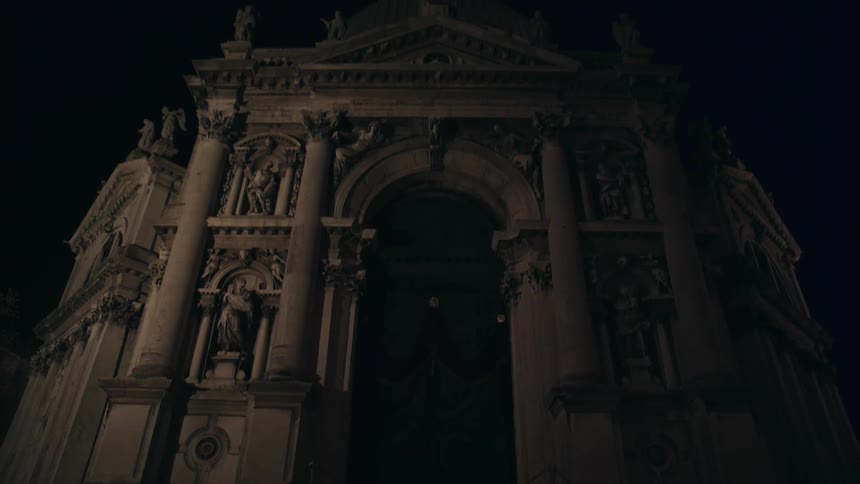 An old stone building at night