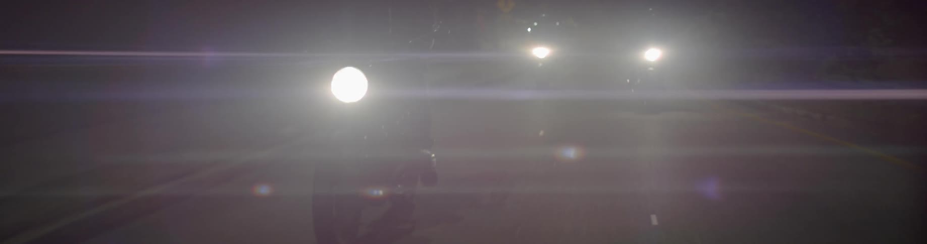 Motorcycles ride together at night