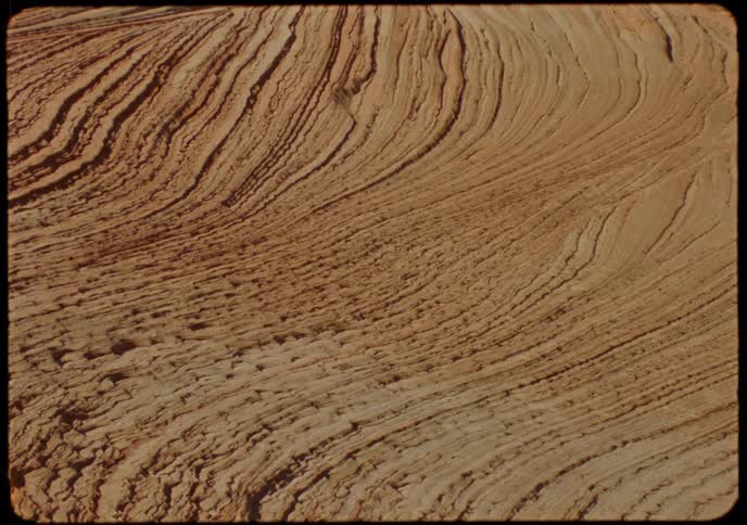 Vintage-style close-up shot of the intricate, layered patterns of a sandstone rock formation