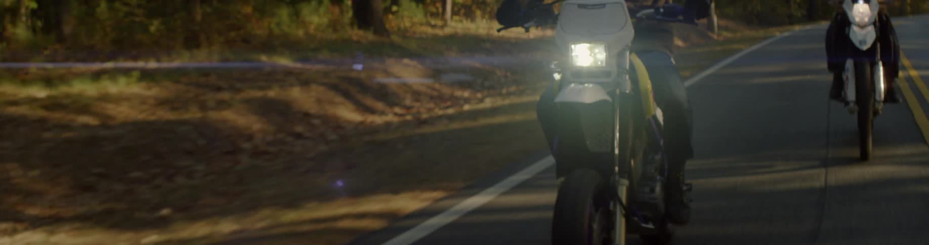A person races their motorcycle down the road