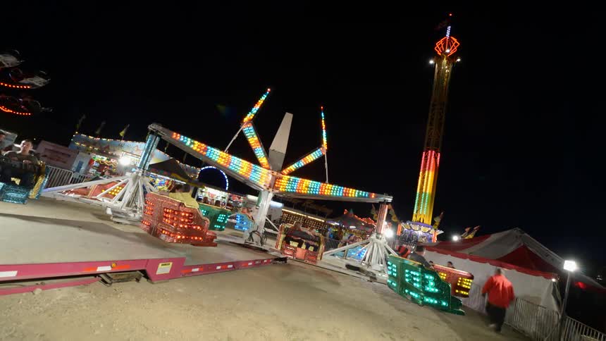 The carnival rides are bright at night
