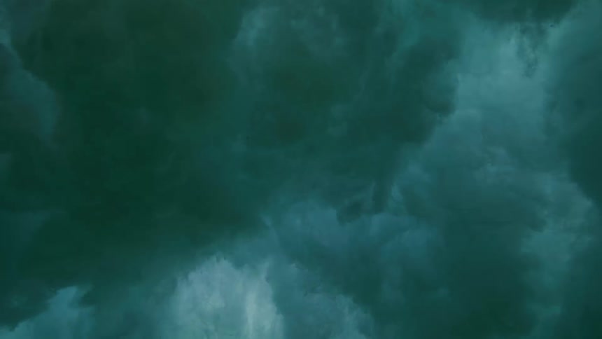 Mesmerizing slow-motion footage captures the turbulent beauty of an ocean wave from an underwater perspective