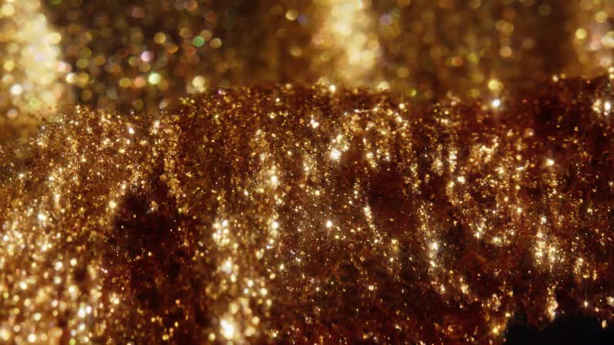 A mesmerizing macro shot of sparkling gold glitter dust slowly shifting and glistening