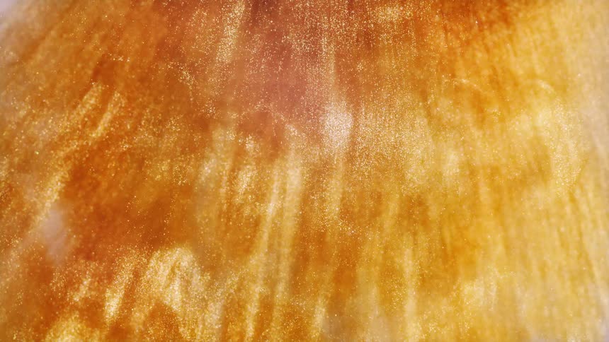 A mesmerizing abstract background of shimmering golden liquid flowing in elegant waves, creating a luxurious and sparkling texture