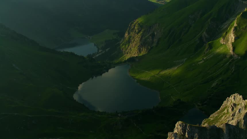 Large body of water in a  green valley