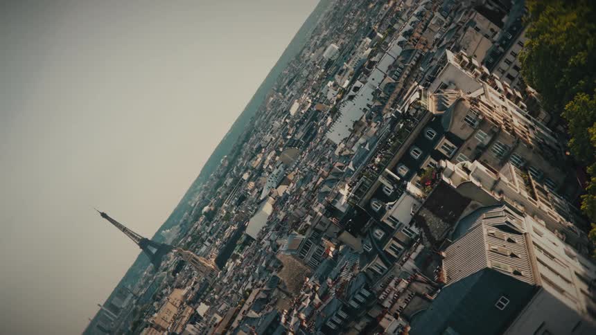 An artistic rotating shot overlooking the rooftops of Paris, France with the Eiffel Tower in the background