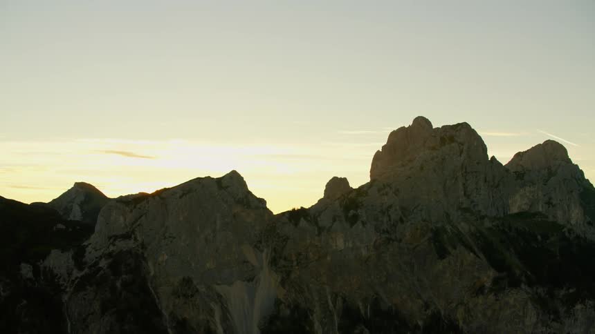 The mountains are jagged and long at sunset