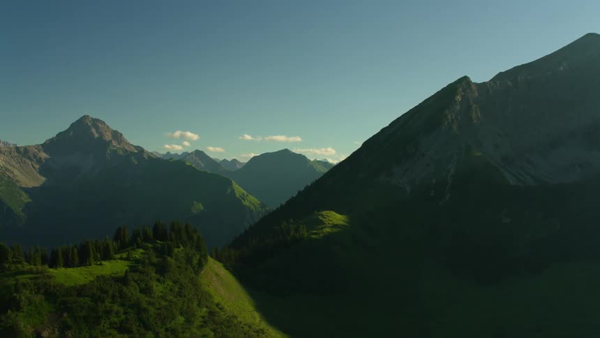 The high mountains have trees and green