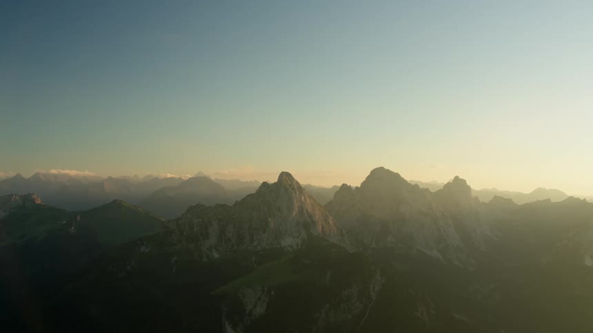 The tall mountains ahead are hazed with fog