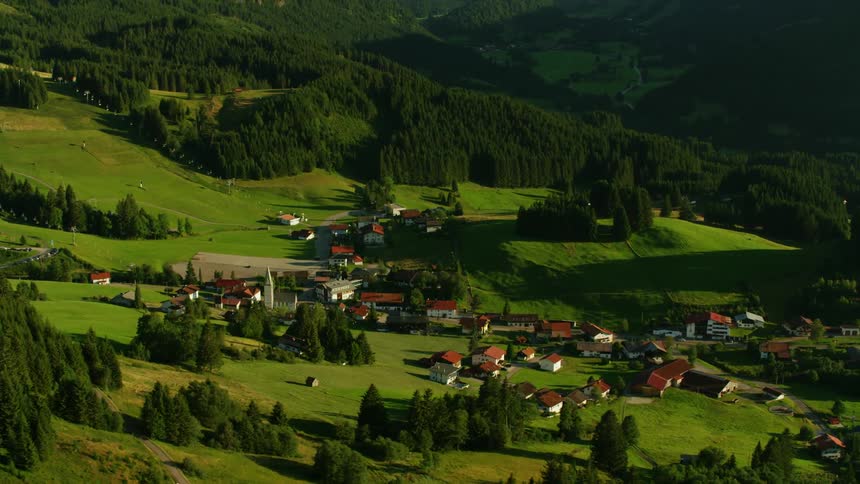 A city in a green forested valley