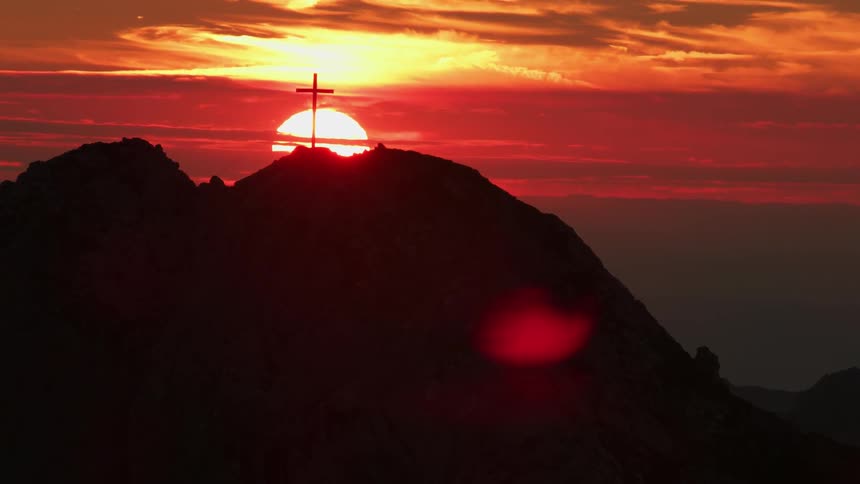The tall mountain has a red sky at dawn