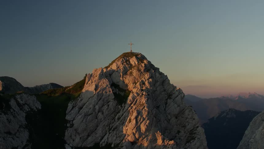 Large cross sitting high above on a mountaintop