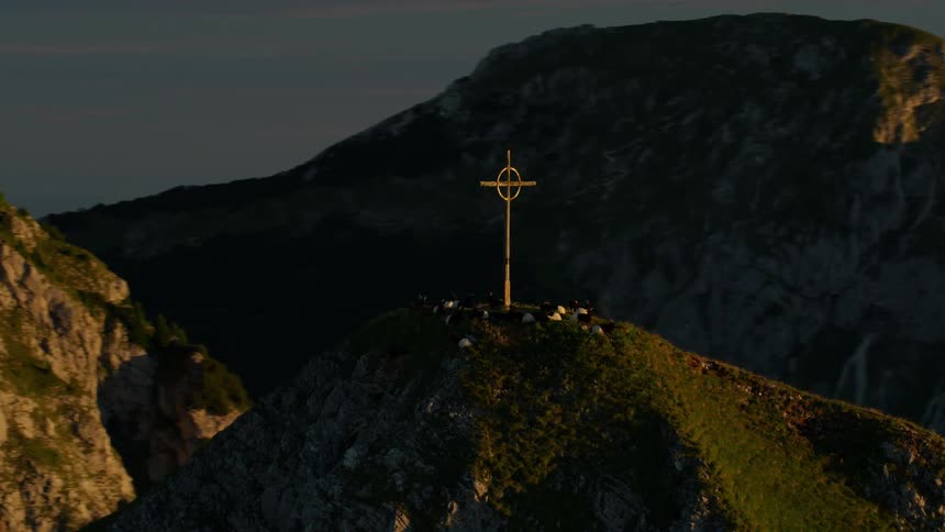 A cross sits on top of this tall mountain
