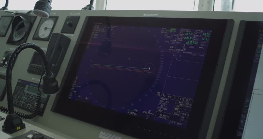 A detailed view of the electronic chart display and information system on the navigation bridge of a large ship