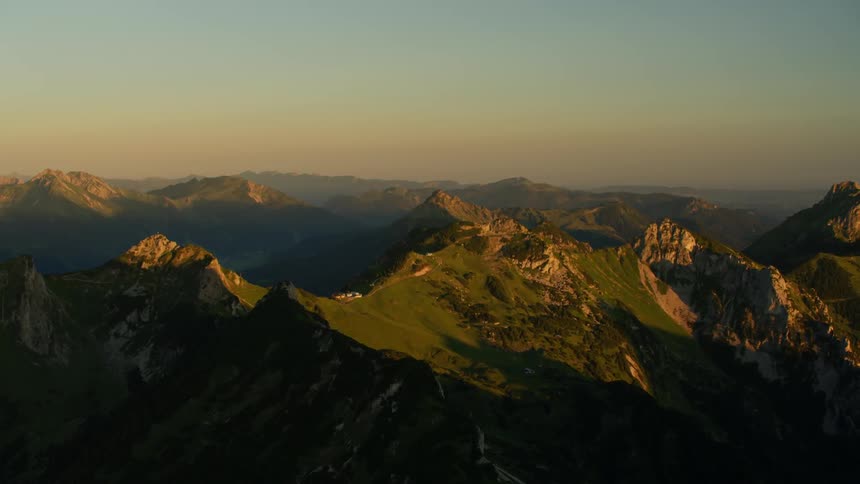 The row of mountains below are covered with green