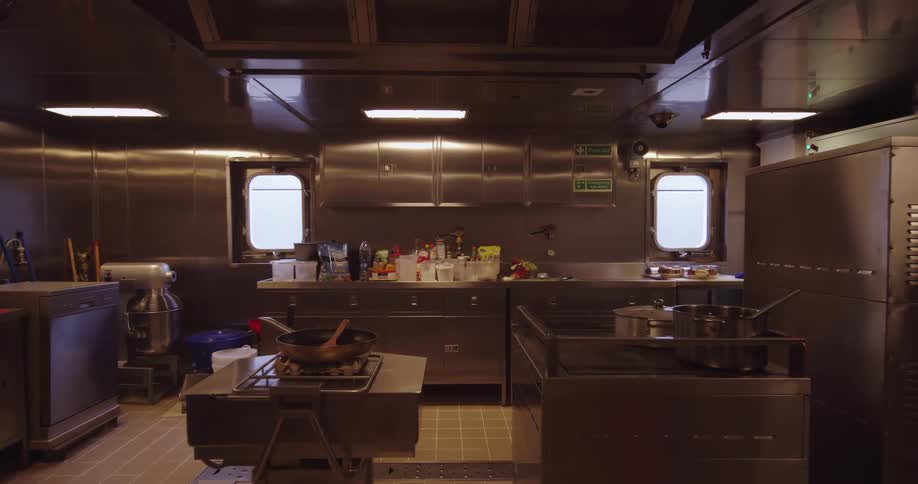 Empty professional stainless steel kitchen galley on a large seafaring vessel