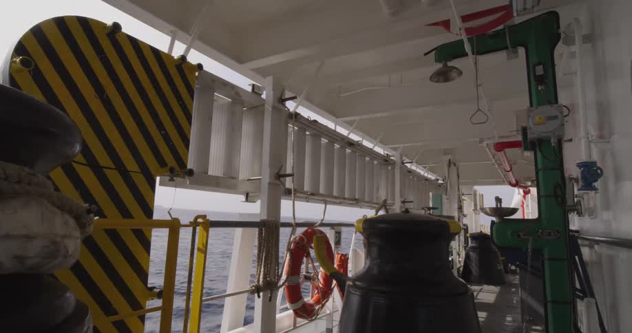 A static view from the deck of a large vessel sailing on the open ocean