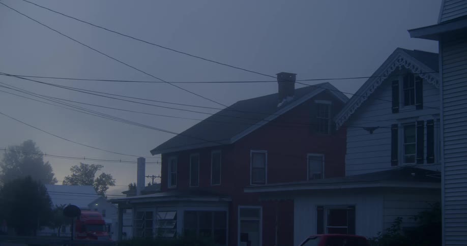 Mist hangs in the air at dawn in a rural community