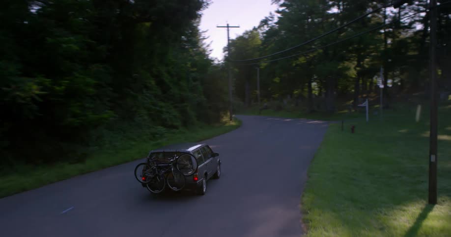A car makes many turns on the winding road
