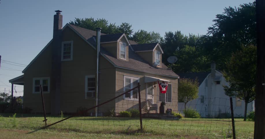 A large home sits behind the fence