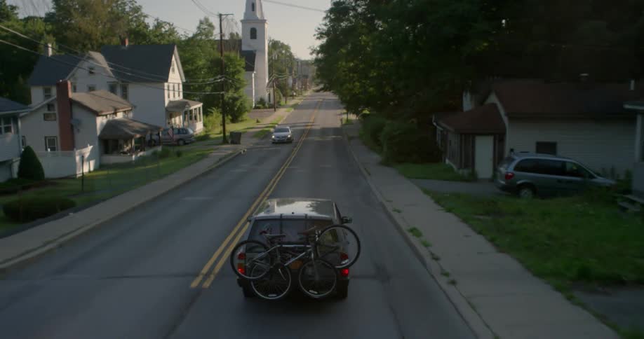 Cars travel both ways on a road in town