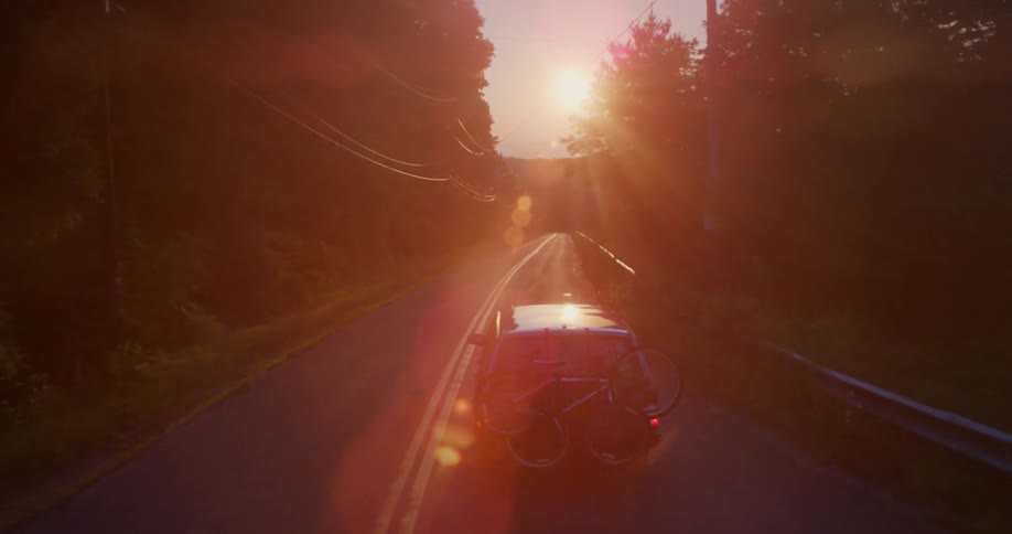 Car driving down a country road at night