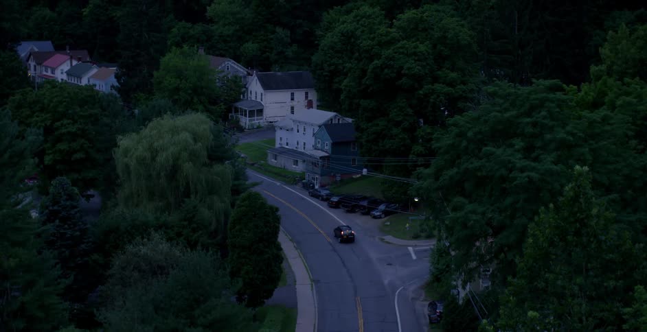 Vehicle driving an urban road at dusk