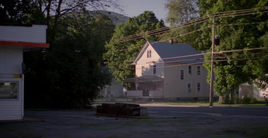 A white house surrounded by trees