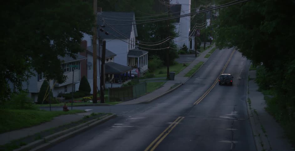 A car drives through a residential area