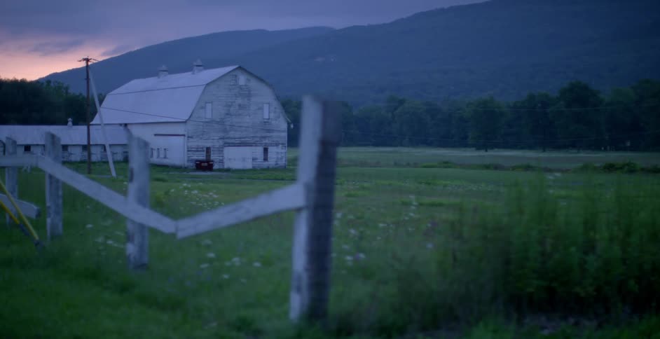 Tattered fence and a barn in the country