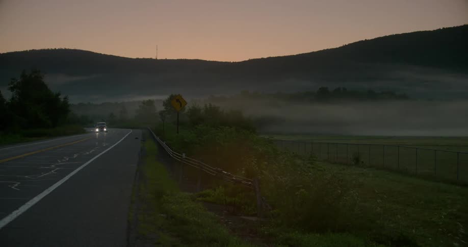 A single car turns around the small road
