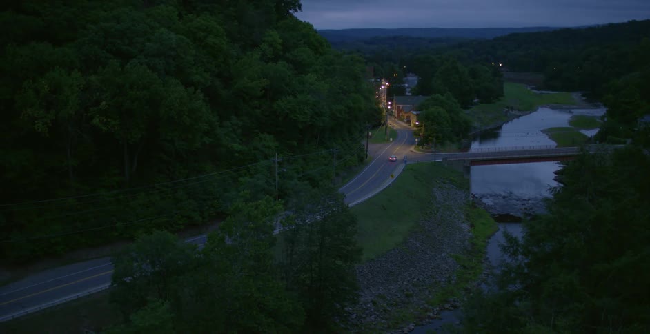 Car driving down a country road at night