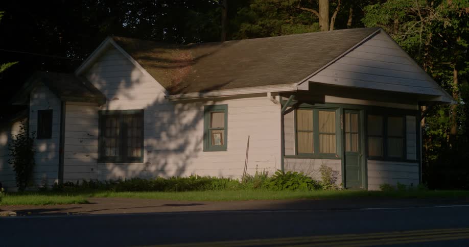 A white house sits on a green lawn