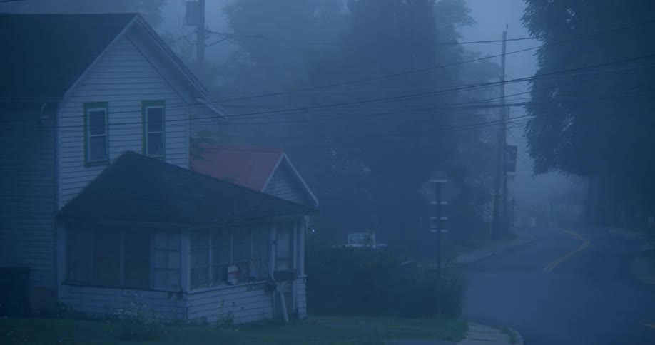 A house is shown on a foggy day