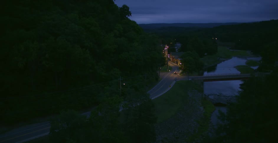 Vehicles drive around the road at sunset