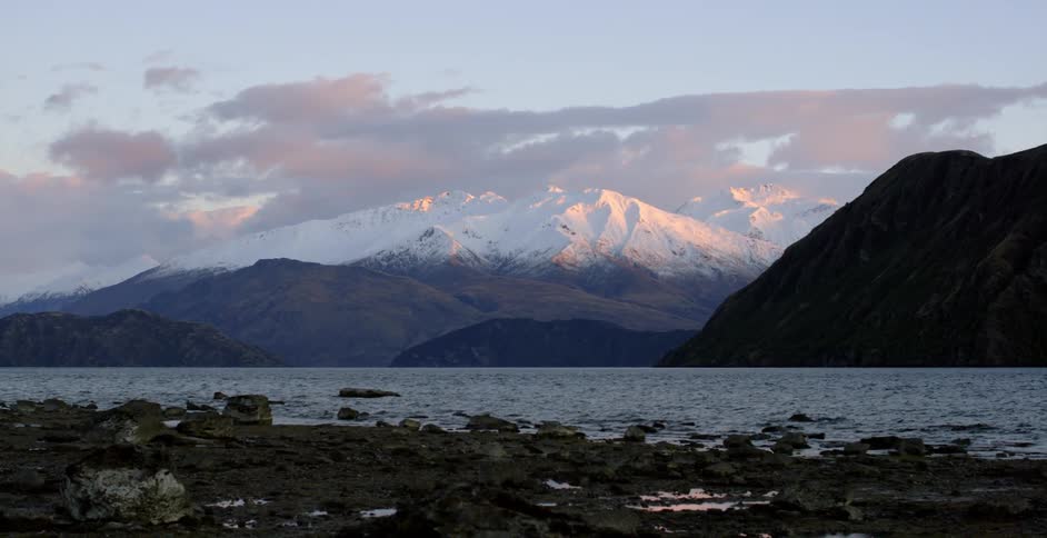 A lake sits before the snow covered mountain
