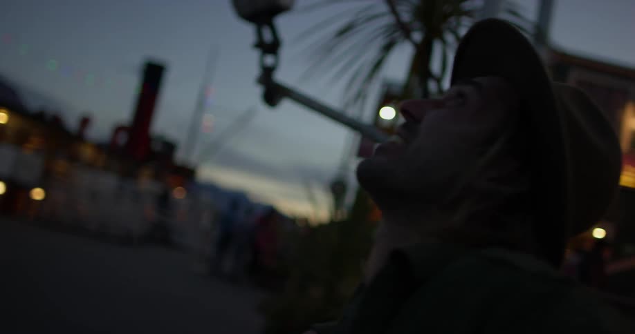 A man in a hat laughs and swings