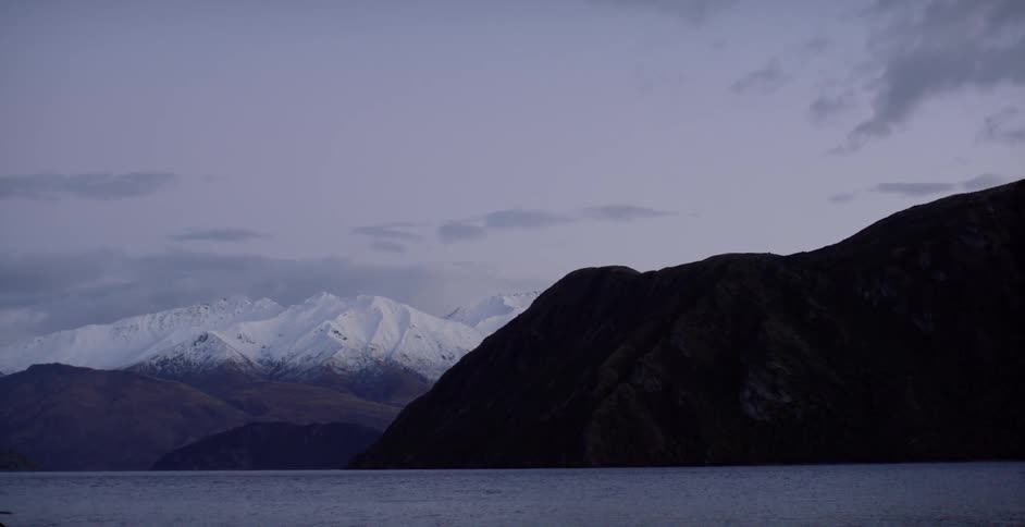 Snow capped mountains near dusk