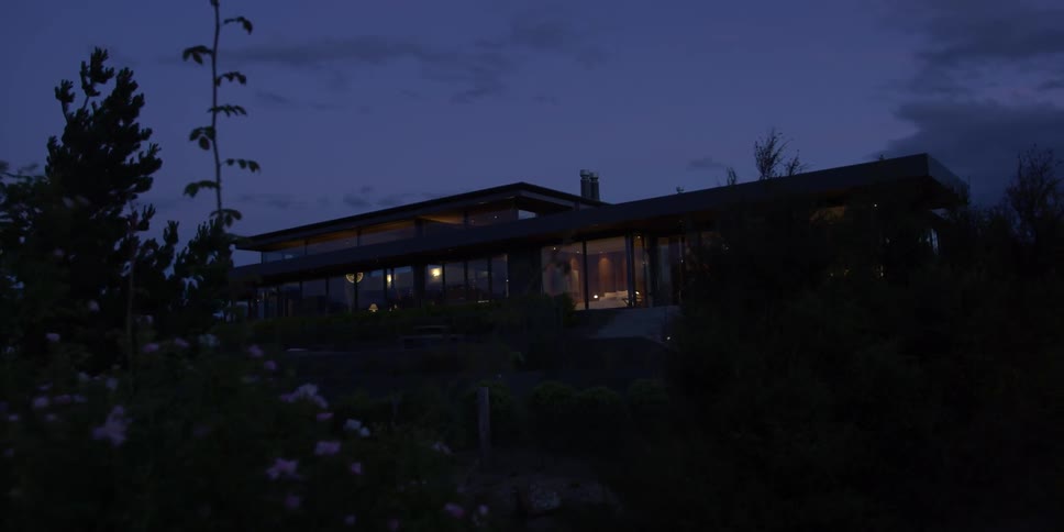 Dark cabin in the middle of a field at night