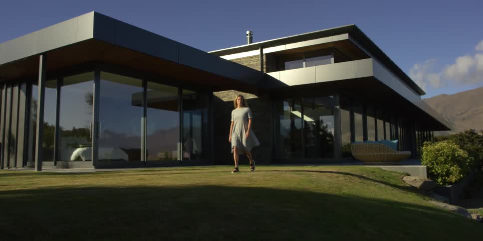 A woman walks out onto her lawn