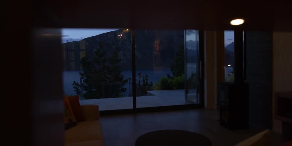 The living room has large windows by the wall